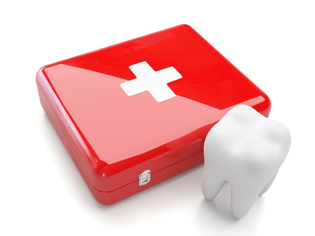 Large model tooth next to red emergency kit